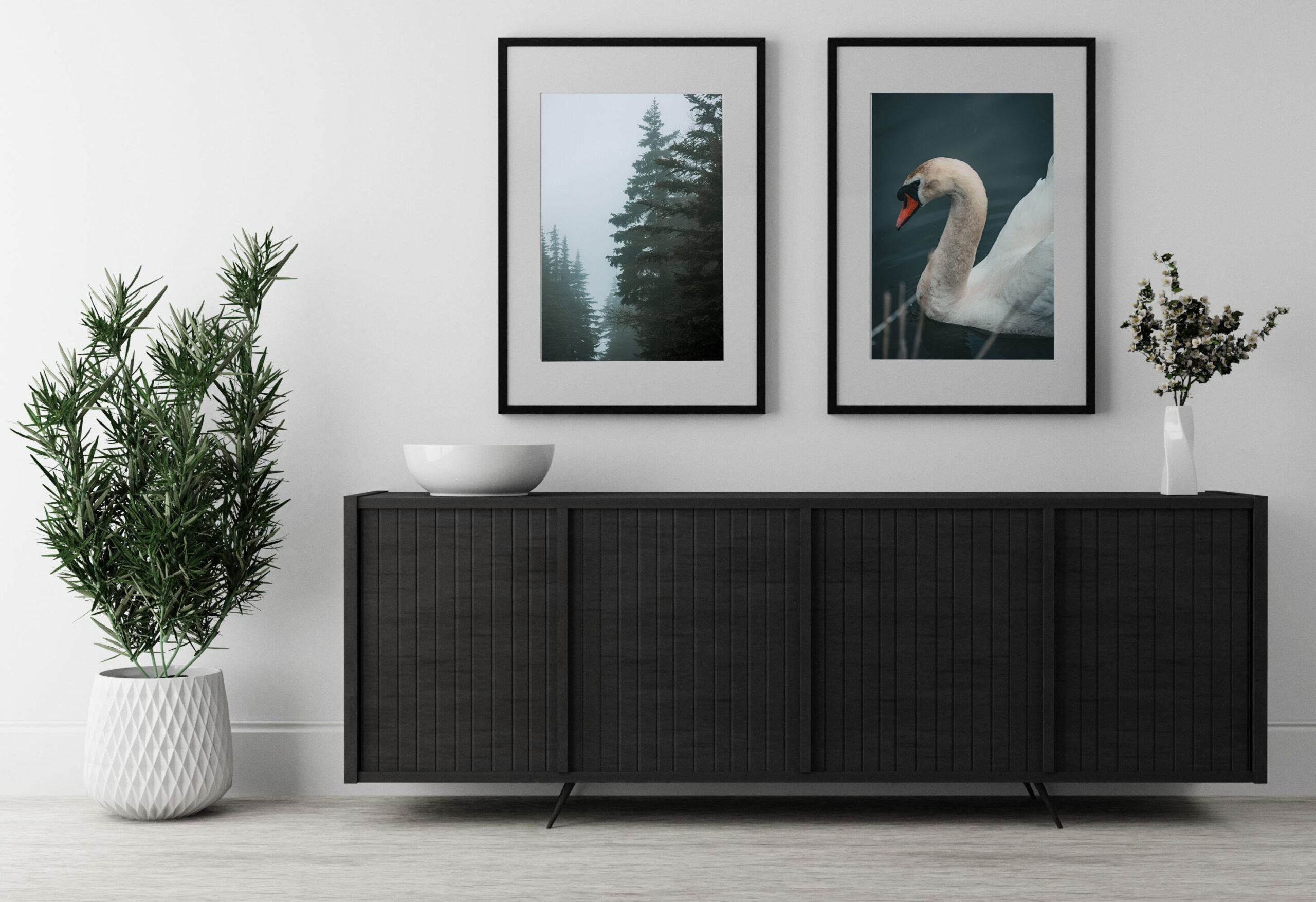 A room with two of the available photos framed on the wall above a dark wood media console.